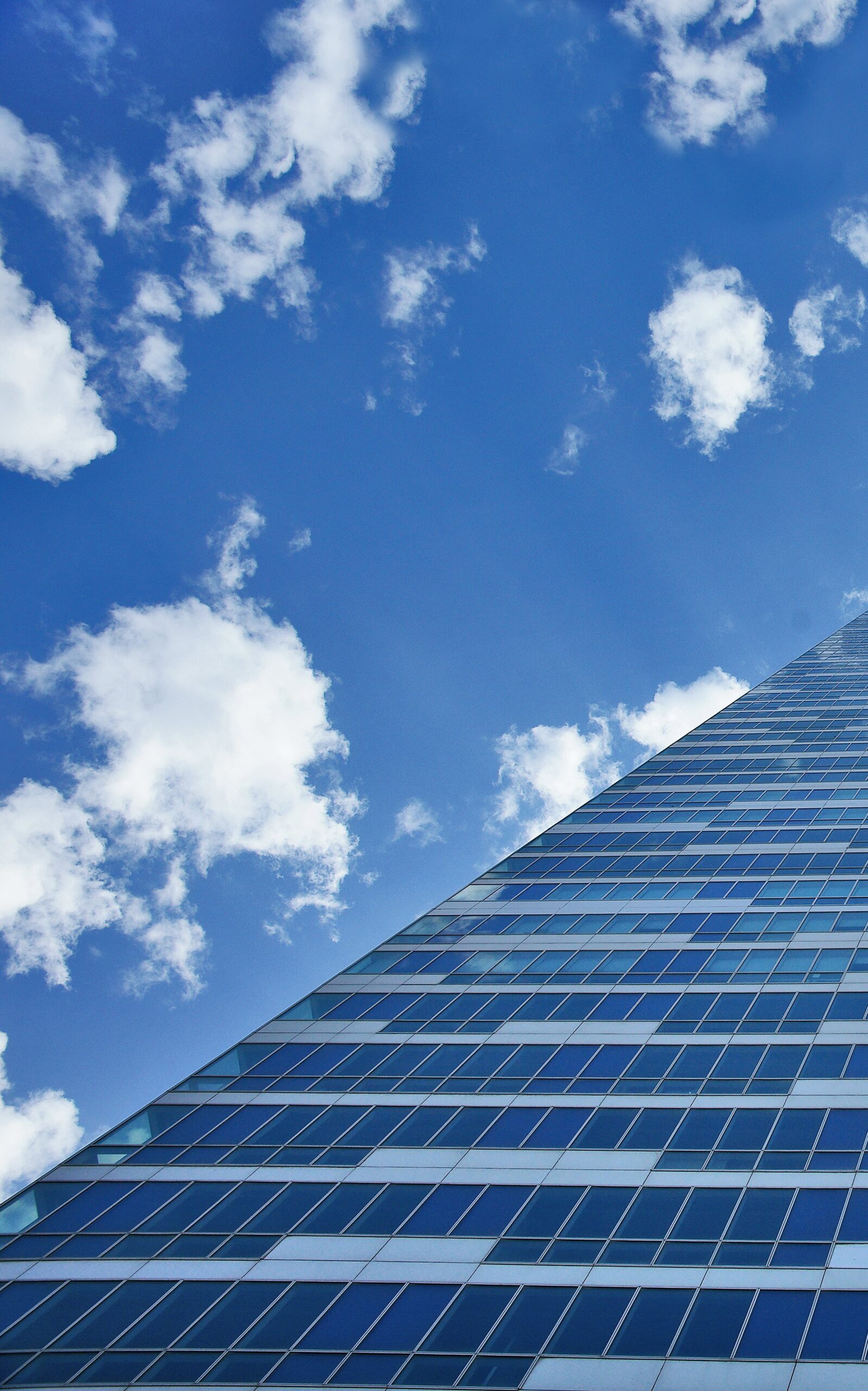 glass-building-with-clouds-background-min